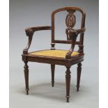 A French fruitwood fauteuil, 19th Century, the open back with carved pierced splat, over Egyptian