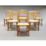 A set of six beech and rush-seated Sussex chapel chairs, early 20th century, the curved top rail