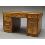 An oak pedestal desk, early 20th Century, the rectangular top inset with red leather writing