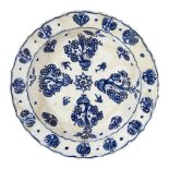 An Iznik pottery dish, Turkey 16th century, of deep form, with sloping sides and cusped rim,