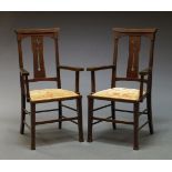 A pair of Arts & Crafts mahogany armchairs, early 20th Century, with pierced back above