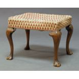 A George III mahogany stool, the seat upholstered in cream and burgundy fabric, on cabriole legs