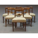 A set of six Regency mahogany and brass inlaid bar back dining chairs, with carved back rails, above