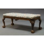 A George II style mahogany long stool, 19th Century, with floral upholstered cushion, above shell