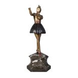 O Marcolin, an Art Deco cold-painted spelter and ‘ivorine’ figurecirca 1930, wearing a gilt dress