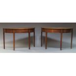 A pair of George III mahogany demi lune tables, originally D ends from a dining table, the frieze