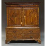 A Queen Ann walnut cabinet on chest, the moulded cornice above concealed frieze drawer, over two