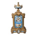 A Victorian gilt spelter and Sevres style porcelain mounted mantel clock, the case with urn finial