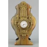 A French onyx and gilt metal mounted timepiece, late 19th/early 20th century, the shaped hard