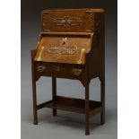 An Arts and Crafts oak bureau, early 20th century, with applied moulded decoration in the oriental