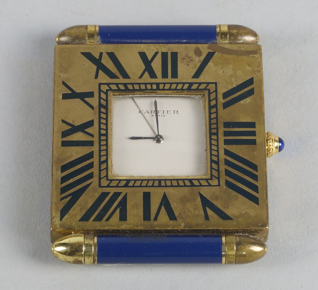 A Cartier gilt metal and blue enamel clock, with square body and roman numeral chapter ring, with