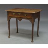 A George II oak low boy, the rectangular top above one frieze drawer over shaped apron, on