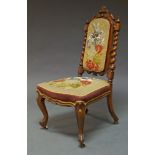 A Victorian walnut side chair, the crest rail with carved foliate and scrolling decoration flanked