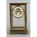 A French gilt brass miniature carriage clock, 20th century, the dial and side panels of white enamel