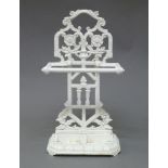 A Victorian Aesthetic movement cast iron white painted stick stand, the pierced back with floral and