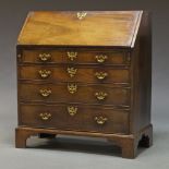 A George III mahogany bureau, the fall front enclosing writing surface and an arrangement of drawers