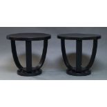 A pair of Art Deco ebonised side tables by Fischel, early 20th Century, the circular tops above