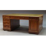 A large Victorian mahogany partners desk, the rectangular top inset with green leather writing