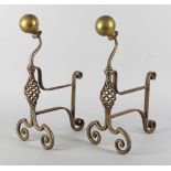 A pair of wrought iron and brass andirons, 19th century, with brass ball finials above writhen