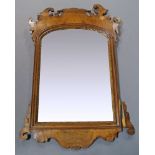 A George II style mahogany and parcel gilt fretwood mirror, 19th Century, the arched mirror plate