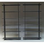 A pair of black lacquered free standing shelving units, of recent manufacture, each with six