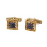 A pair of 18ct. gold, sapphire cufflinks, by Cartier, each with square openwork ropework panel set