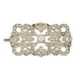 An Art Deco style diamond plaque brooch, the rectangular openwork panel set in the centre with an a