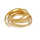 A group of six 22ct. gold bangles, each with chased decoration, approximate total weight 80.0g (6)