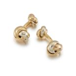 A pair of 18ct. gold cufflinks, by Cartier, of dumbell type with three colour gold knot terminals,