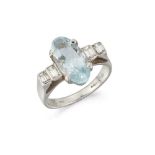An 18ct. gold, aquamarine and diamond ring, the oval-cut aquamarine in claw-set mount with graduated
