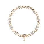 An Edwardian gold, diamond bracelet, composed of a series of openwork navette shaped links each with