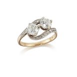 An Edwardian, diamond two stone ring, of crossover design, each diamond weighing approximately 0.
