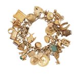 A 9ct. gold charm bracelet, of curb-link design with padlock clasp, suspending various mid 20th