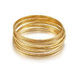 A group of nine bangles, each with milled deocration, all inner diameter 5.8cm (9)