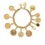 A gold coin bracelet with various charms, the 22ct. gold fancy curb-link bracelet suspending seven