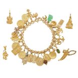 A charm bracelet and five loose charms, the bracelet of fancy-link design suspending various