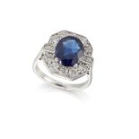 An 18ct gold sapphire and diamond ring octagonal cluster ring, the claw-set oval-cut sapphire