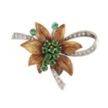 An emerald and diamond brooch, the central circular-cut emerald cluster with textured leaf
