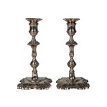 A pair of George III paktong candlesticks, circa 1760, each with square knopped and fluted stem