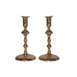 A pair of George III brass candlesticks, probably by E.Berry, late 18th century, each with shell-