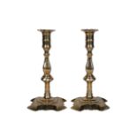 A pair of George III brass candlesticks, third quarter 18th century, the baluster stems above