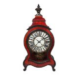 A French red tortoiseshell clock, 19th century, later mounted with an urn form finial, with shaped