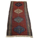 A West Persian runner with four medallions, cut down, 237cm x 106cm, together with a prayer rug with