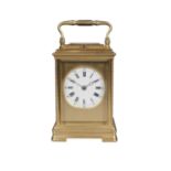 A French brass cased carriage clock, 20th century, the gilt case with beaded decoration to the
