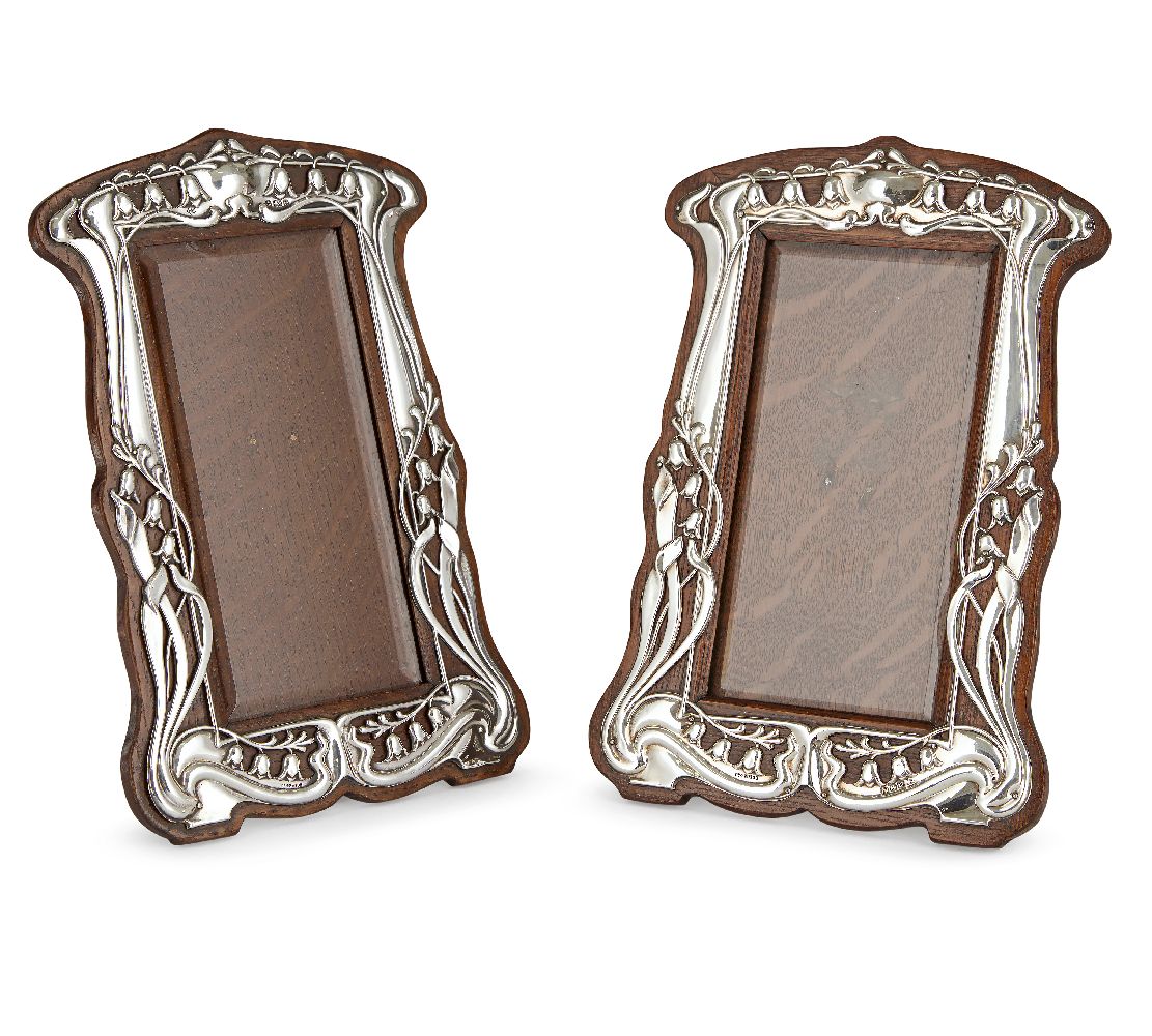 A matched pair of Art Nouveau silver and oak photograph framesMark of Walker & Hall, Sheffield