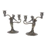 WMF, a pair of Art Nouveau pewter and brass figural candelabrac.1906, faint stamped maker's marks,