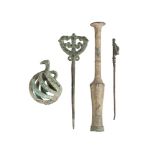 A group of Luristan bronze attachments, 1000-650 BC., comprising an openwork bell, two clothes pins,