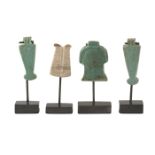 A group of four amulets, comprising an Egyptian stone double ostrich plume amulet Late Dynastic