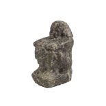 An Egyptian Diorite seated figure, Predynastic period, circa 3200BC., shown with knees raised,