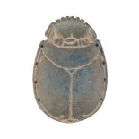 An Egyptian scarab with blue faience inlay, 6.5cm. long Provenance: Collection of George and Dora